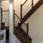 after-renovation-down-town-toronto-box-stair-small-landing-new-stringers-solid-oak-dark-stain-glass-railing-square-solid-oak-wood-posts-